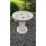 A Stone Bird Bath with columned supports.