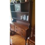 A late 19th early 20th Century Oak Dresser with a stained glass top door.