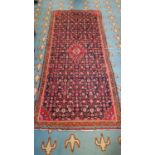 An Iranian Rug / Runner with Burgundy ground allover decoration and multi borders. 277 x 117cm.