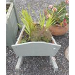 A Timber wheelbarrow Planter.