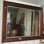 A good early 20th Century Hardwood Mirror with a silvered filet and carved frame.