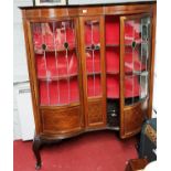 An early 20th Century Inlaid Mahogany Display Cabinet of serpentine fronted design with double
