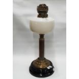 A late 19th Century Brass and Ebonised Lamp with a frosted glass bowl.