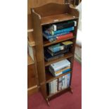 A nice narrow early 20th Century Mahogany Open Shelves along with a quantity of hardback books.