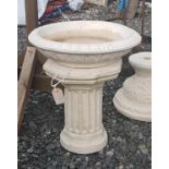 A Stone Bird Bath with columned supports.