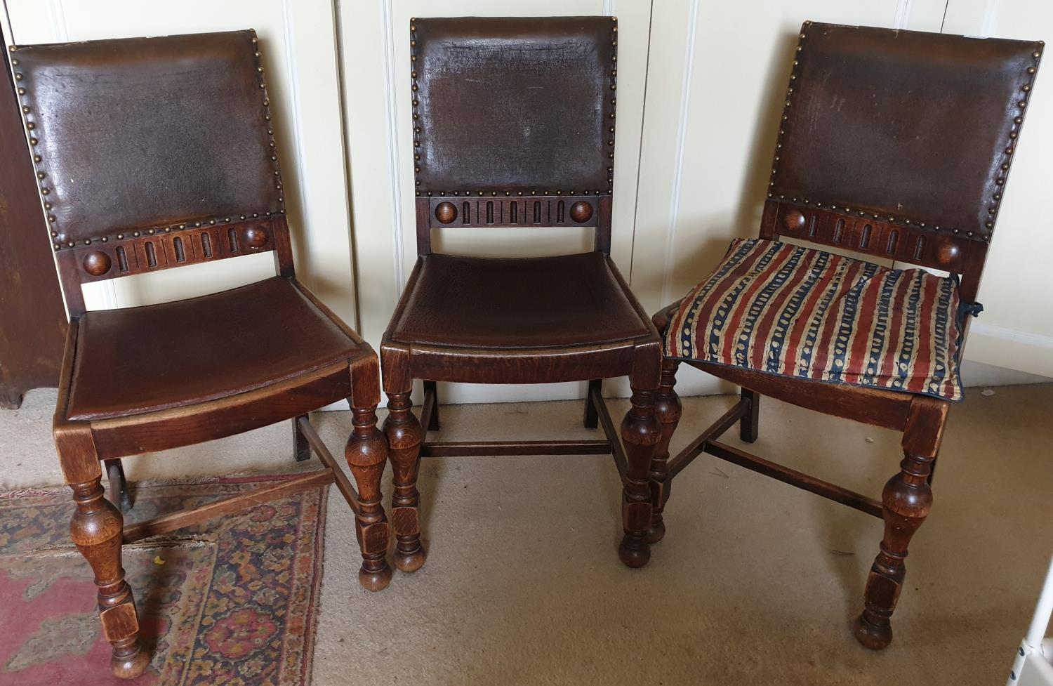 Three early 20th Century Oak Chairs with original leather seats.