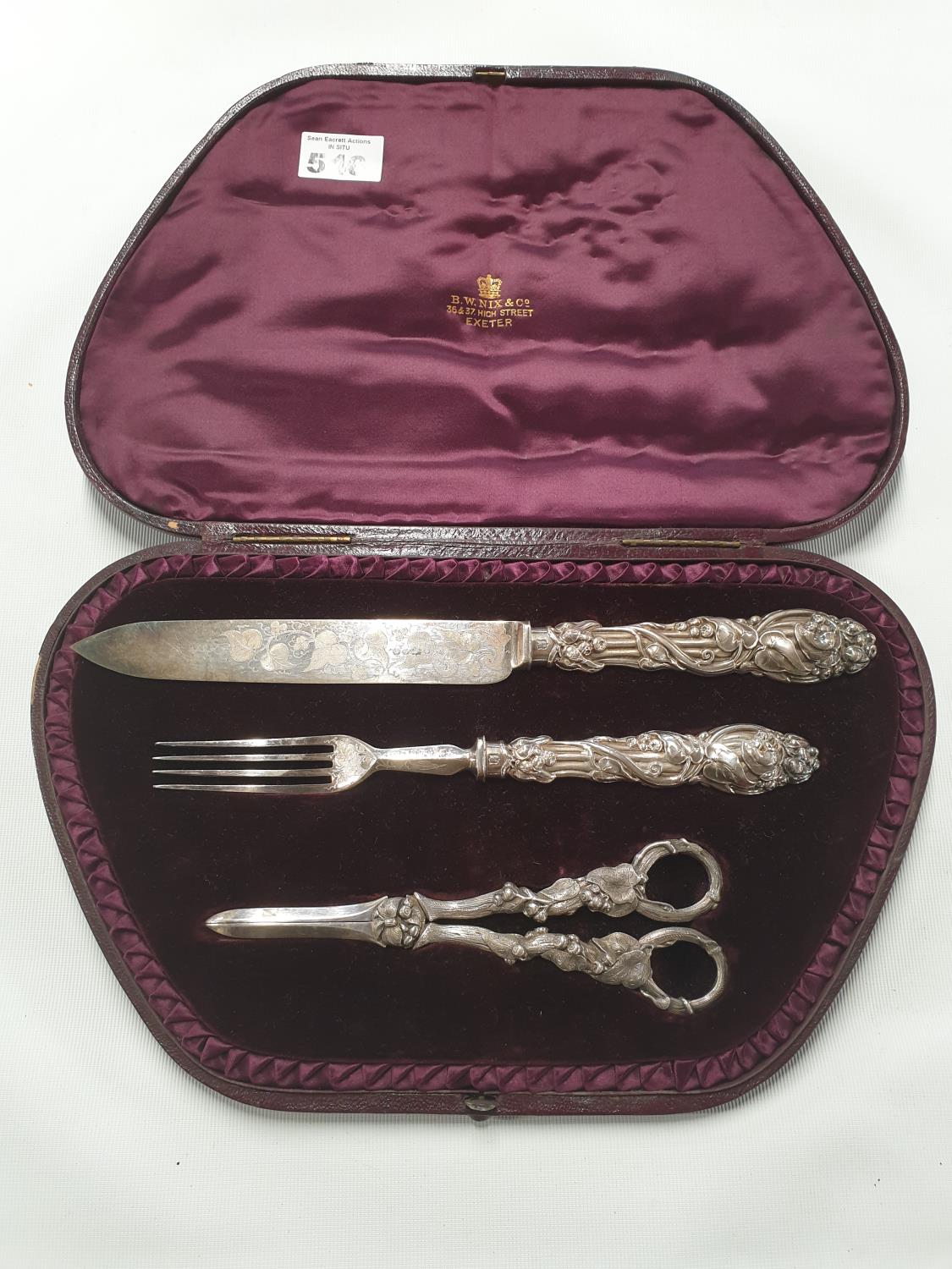 A really good cased Grape set to include a Scissors, Knife and Fork. Retailed by R W Nix and Co,