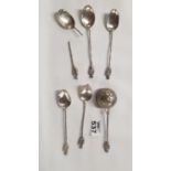 A quantity of Oriental Spoons along with a strainer, probably silver.