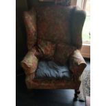 A 19th Century Wingback Armchair with floral upholstery.