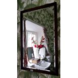 An Edwardian Mirror with bevelled glass.