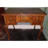 A Georgian Walnut Lowboy with a three drawer frieze and cabriole supports. 94 cms x 56 d x 75 cms h.