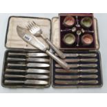 Two sets of silver handled Knives along with a Fish serving set and a cased set of Salts.
