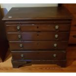 A Georgian Mahogany miniature Chest of Drawers with brushing slide.