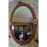 A late 19th early 20th Century Oval Gilt Mirror with Sevre style plaques.