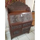 A 19th Century Kashmere Peduk Bureau with highly carved outline and fitted interior.