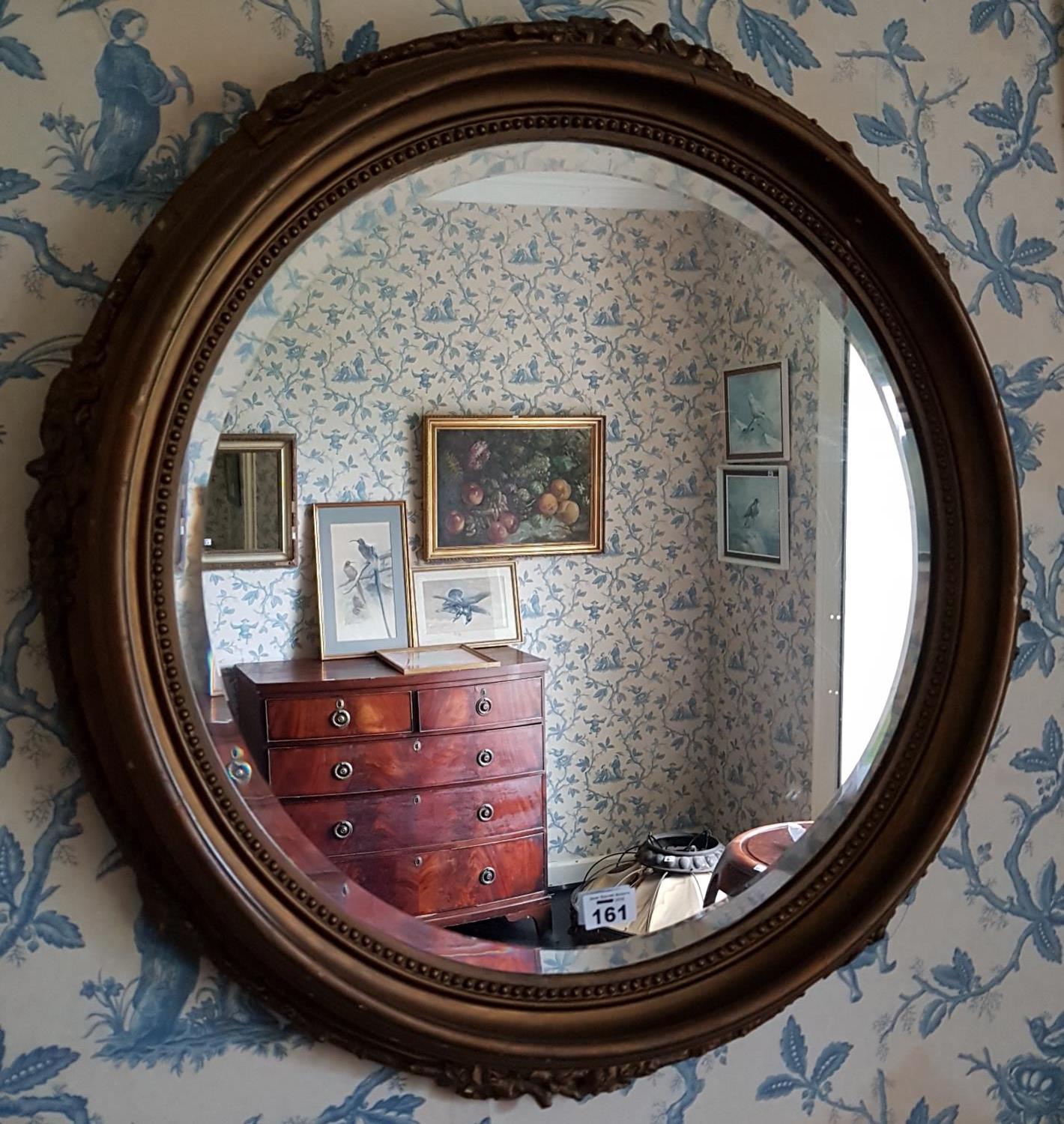 A late 19th Century Plaster Gilt Circular Mirror with bevelled glass. 62cm diameter.