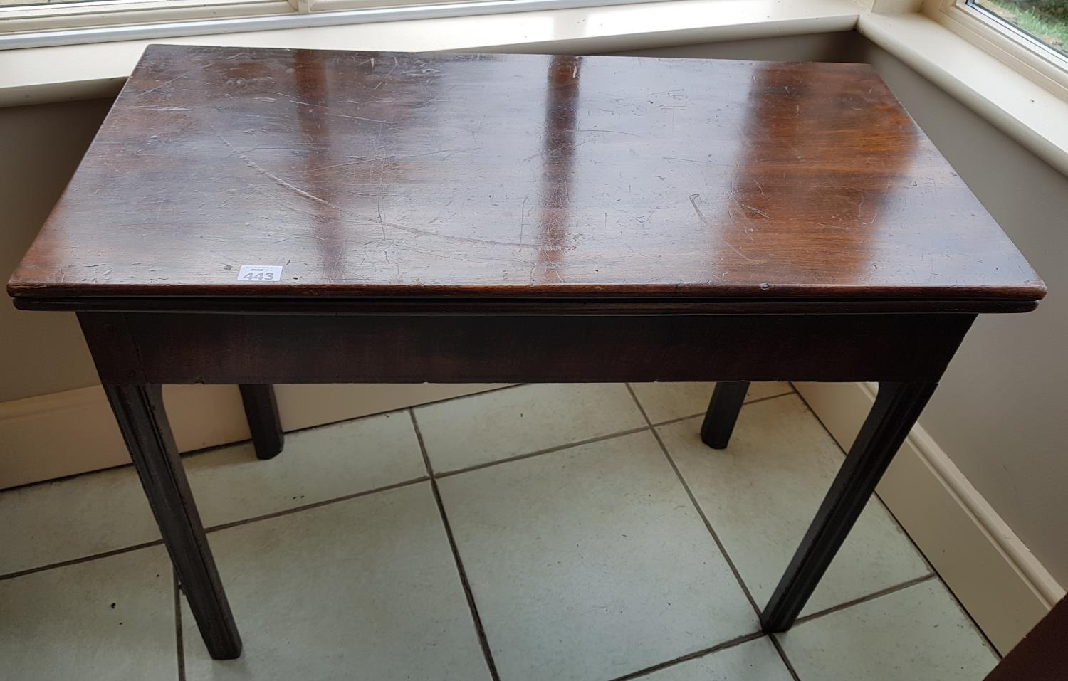 A Regency Mahogany Foldover Tea Table. 90 cms w x 44 cms d x 73 cms h.