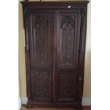 An early 19th, possibly earlier, Oak Cupboard with highly carved double doors. 102 cms w x 51 cms