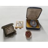 A gold cameo Ring, a Wedgewood Brooch, miniature Carrage Clock and religious Plaque.