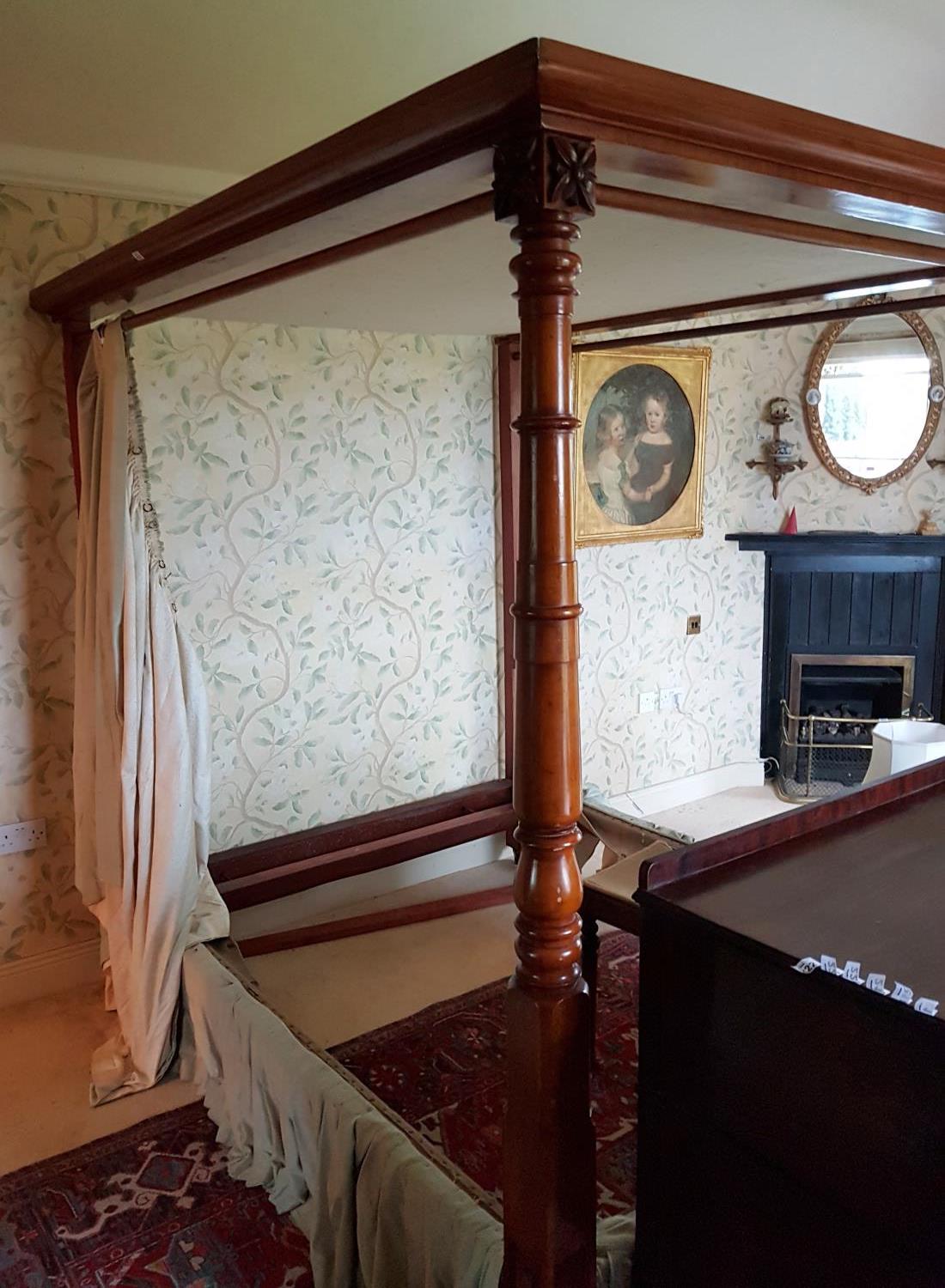 A lovely 19th Century Mahogany Four Poster Bed with turned foot supports.