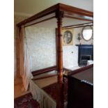 A lovely 19th Century Mahogany Four Poster Bed with turned foot supports.