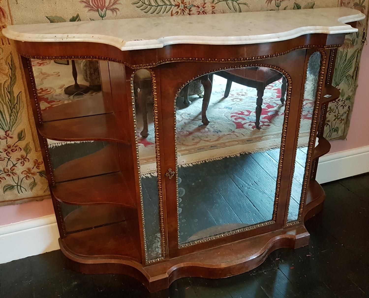 A 19th Century serpentine fronted Credenza with a marble top and single mirrored front door. W136