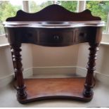A good 19th Century Serpentine fronted Washstand with turned and fluted supports on a platform base.