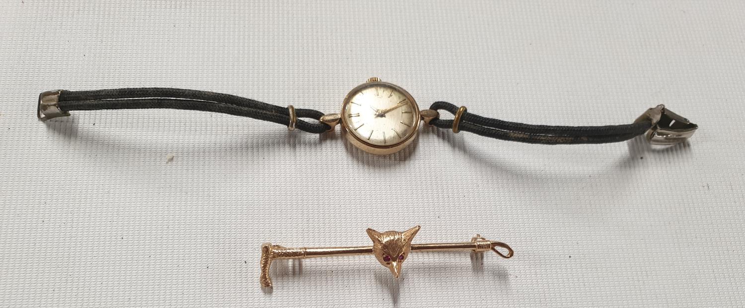 A Garrard ladies wrist Watch along with a 9ct gold Brooch.