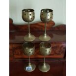 A set of four Brass Candle Holders.