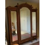 A magnificent 19th Century Walnut and Ormolu Continental Wardrobe/Armoire with an archtop pediment