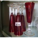 A set of six late 19th early 20th Century Cranberry Glasses with gold trim.