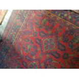 A large Burgundy ground Rug with allover decoration. 410 x 260cm.