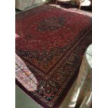 A large Red Ground Persian Mashad Carpet with a beautiful medallion design.Size W 294 x L 384.