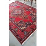 A Persian Red Ground Tabriz Carpet.Size 285 x 198cms.