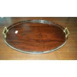 A 19th Century Oval Tray with brass handles.