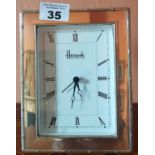 A Harrods Silver framed Clock.size 13 X 16.5cms.
