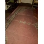A very large Pink ground Rug with multi borders.