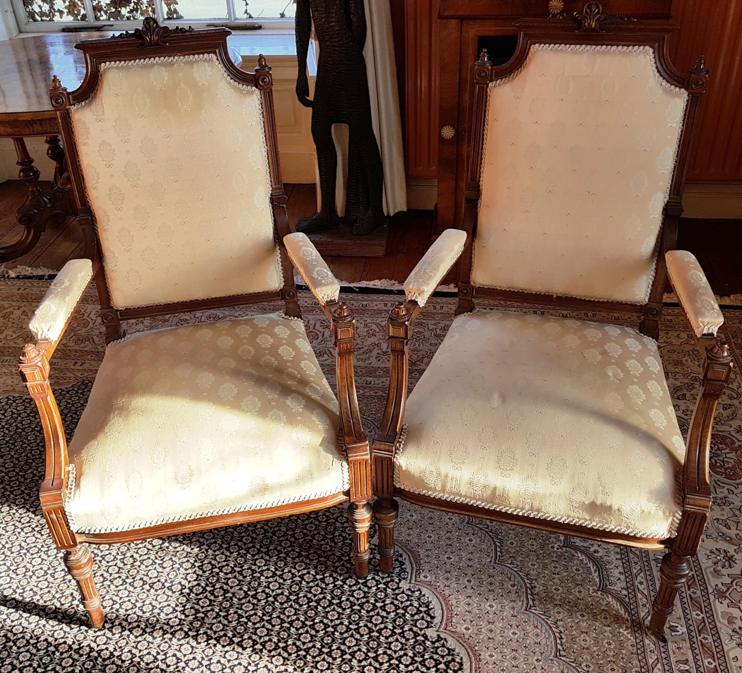 A lovely pair of 19th Century Walnut Armchairs with gilt decoration and turned fluted supports.