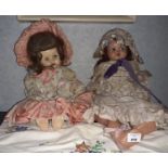 A group of Vintage Porcelain Dolls and a rocking chair.