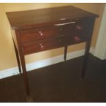 A Georgian Mahogany two drawer Side Table on tapered supports.