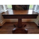 A Georgian Mahogany Foldover Tea Table on a platform base.