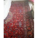 A large red ground Persian Mashad Carpet with a beautiful floral medallion design. 375 x 302 cms.