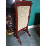 A 19th Century Mahogany Fire Screen with a fabric panel centre.