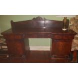 An Irish William 1Vth Mahogany Pedestal Sideboard with a carved and moulded base and doors and