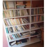 A large quantity of Books on white shelves.