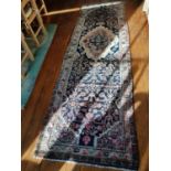 A blue ground Persian Soroka Runner with all over pattern and a medallion design.