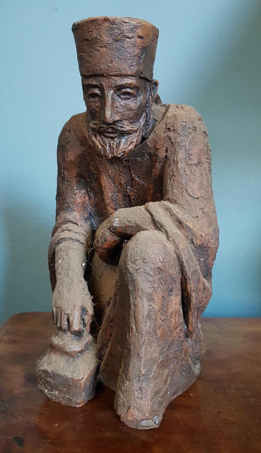 A Terracotta Figure of an Oriental Man. 21cm high.