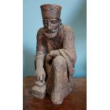 A Terracotta Figure of an Oriental Man. 21cm high.