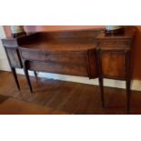An early 19th Century Regency Mahogany Sideboard with reeded outline on square fluted supports.