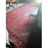 A large red ground Persian Kashan Carpet with traditional Kashan medallion design. 400 x 300 cms
